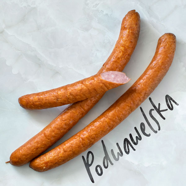 Podwawelska - Polish steamed sausage, perfect for cooking and grill. On white marble background