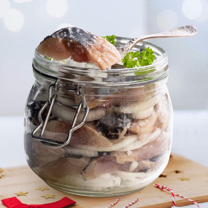 Pickled herring in vinegar with onions, in a jar