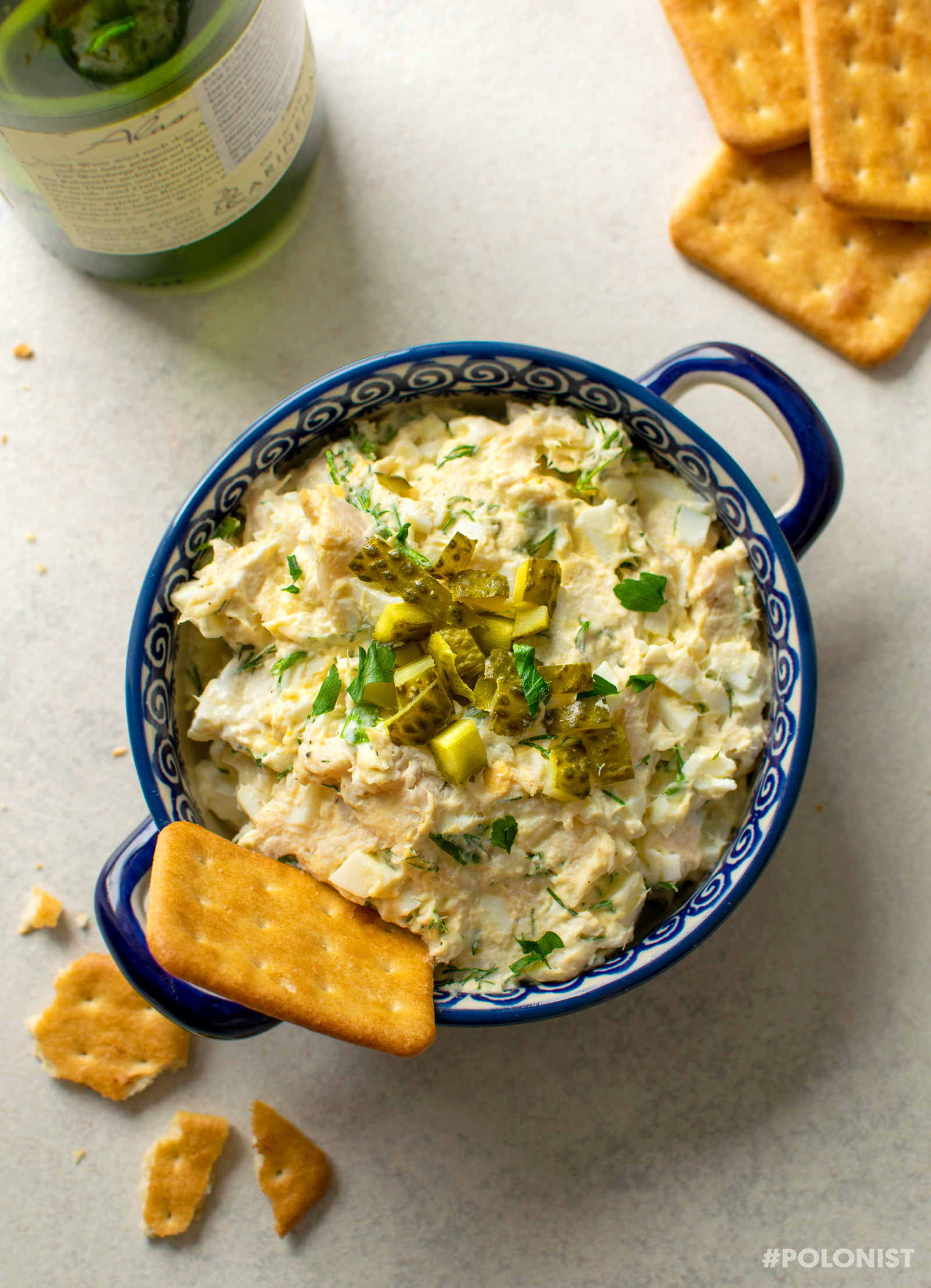 A bowl full of Smoked Trout Dip with  Cream Cheese, Eggs and Horseradish, served with crackers.