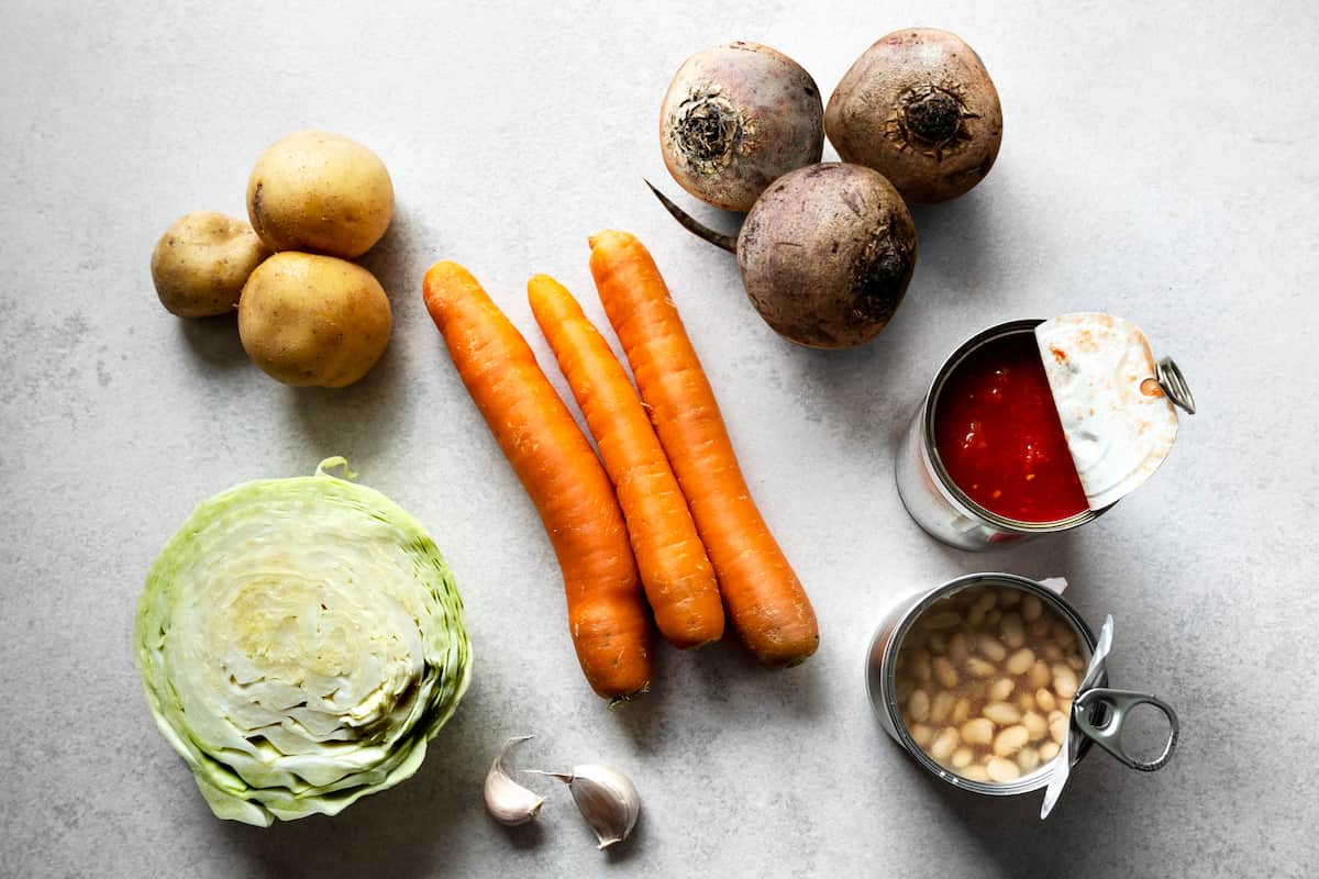 Ingredients for Barszcz Ukraiński: potatoes, white cabbage, carrots, beetroots, can of tomatoes and can of white beans